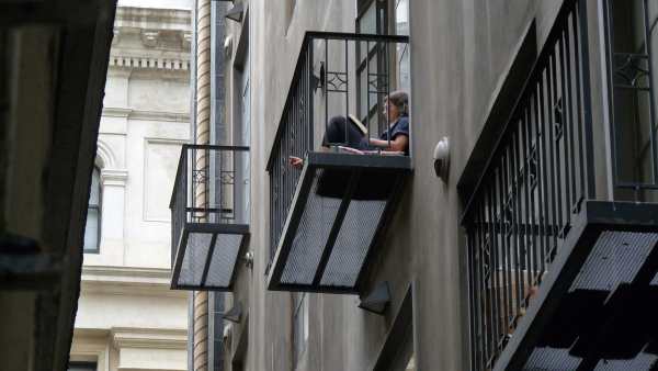 student studying on balcony