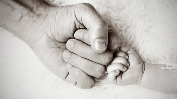 Child and adults hands touching