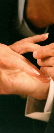 Close-up of ring being placed on bride